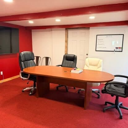 Office meeting room with a clean conference table and chairs