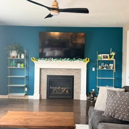 Living room with a tidied fireplace mantel and clear surfaces